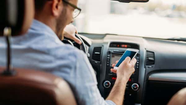 Young Man Texting While Driving Stock Photo